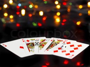 2204708-dice-and-playing-cards-poker-royal-flesh-on-back-background-casino-lights